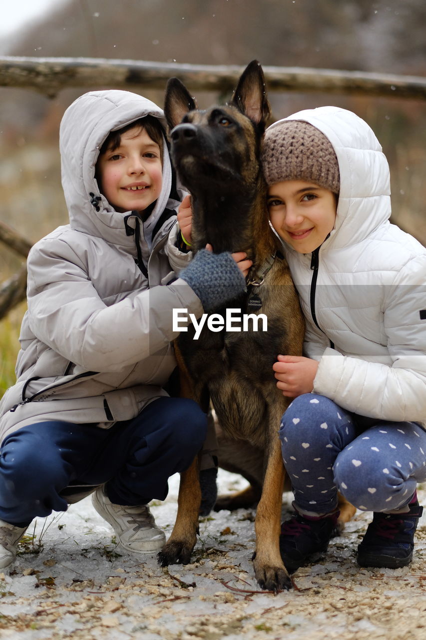 Portrait of kids with dog belgian malinois