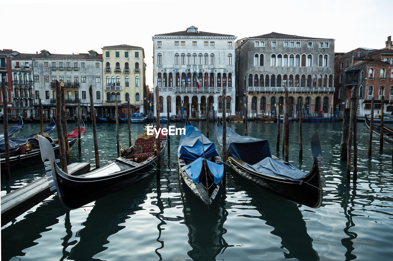 Gondolas moored on grand canal in city