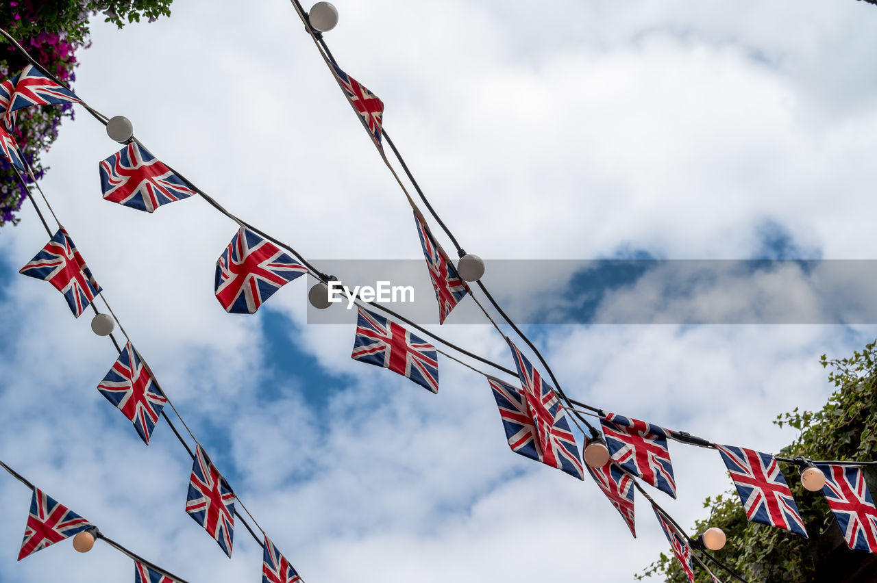 British flags and light bulbs hanging against a sky