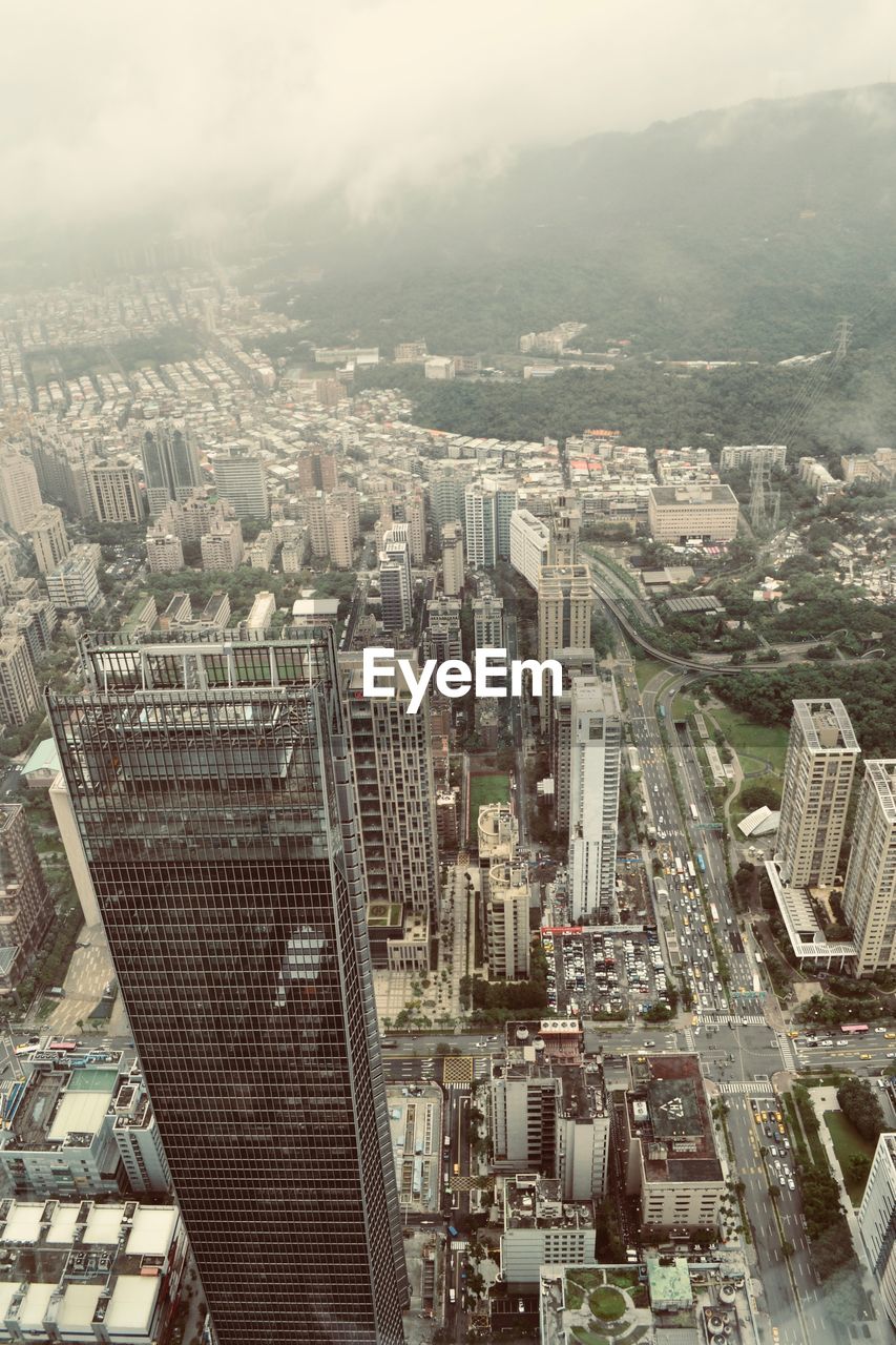 High angle view of modern buildings in city against sky