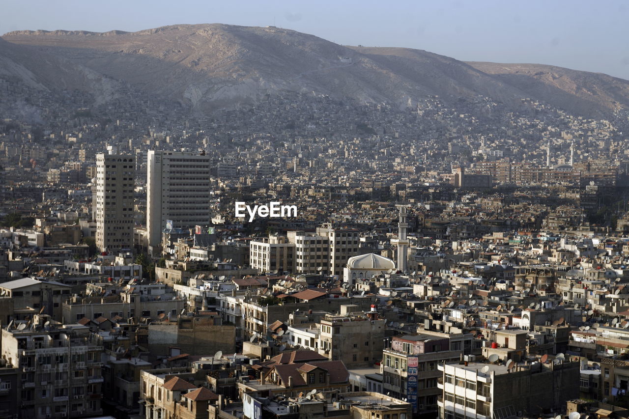 Aerial view of buildings against mountain range