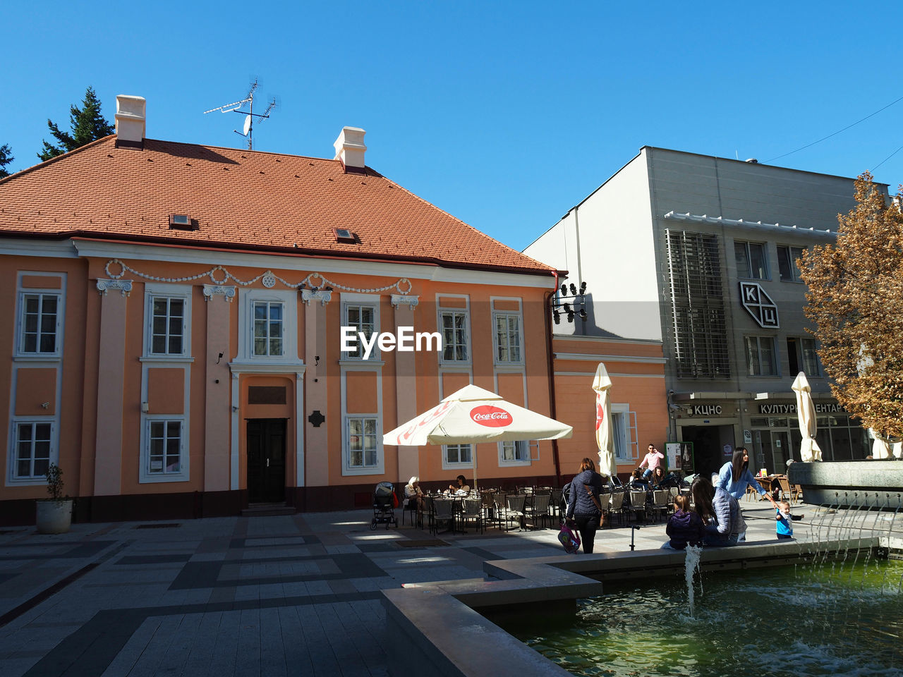 PEOPLE ON STREET BY BUILDINGS AGAINST SKY