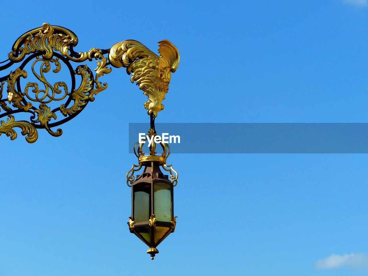 LOW ANGLE VIEW OF WEATHER VANE AGAINST CLEAR BLUE SKY