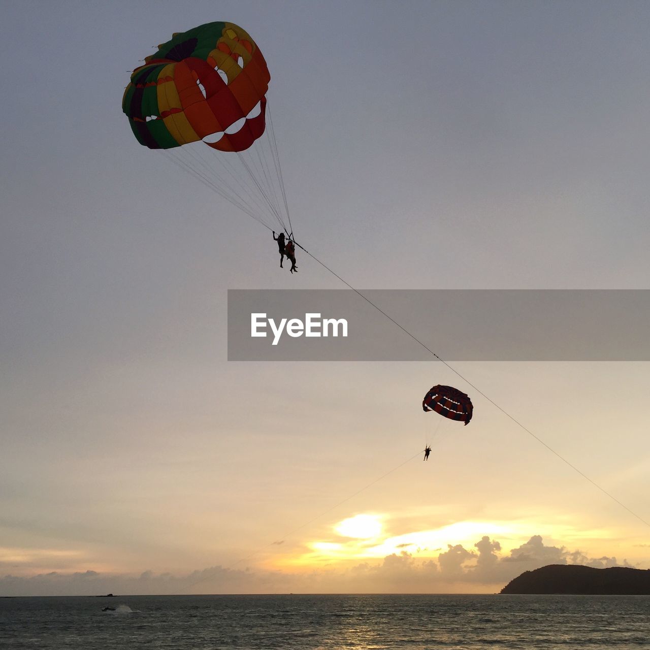 LOW ANGLE VIEW OF PERSON PARAGLIDING