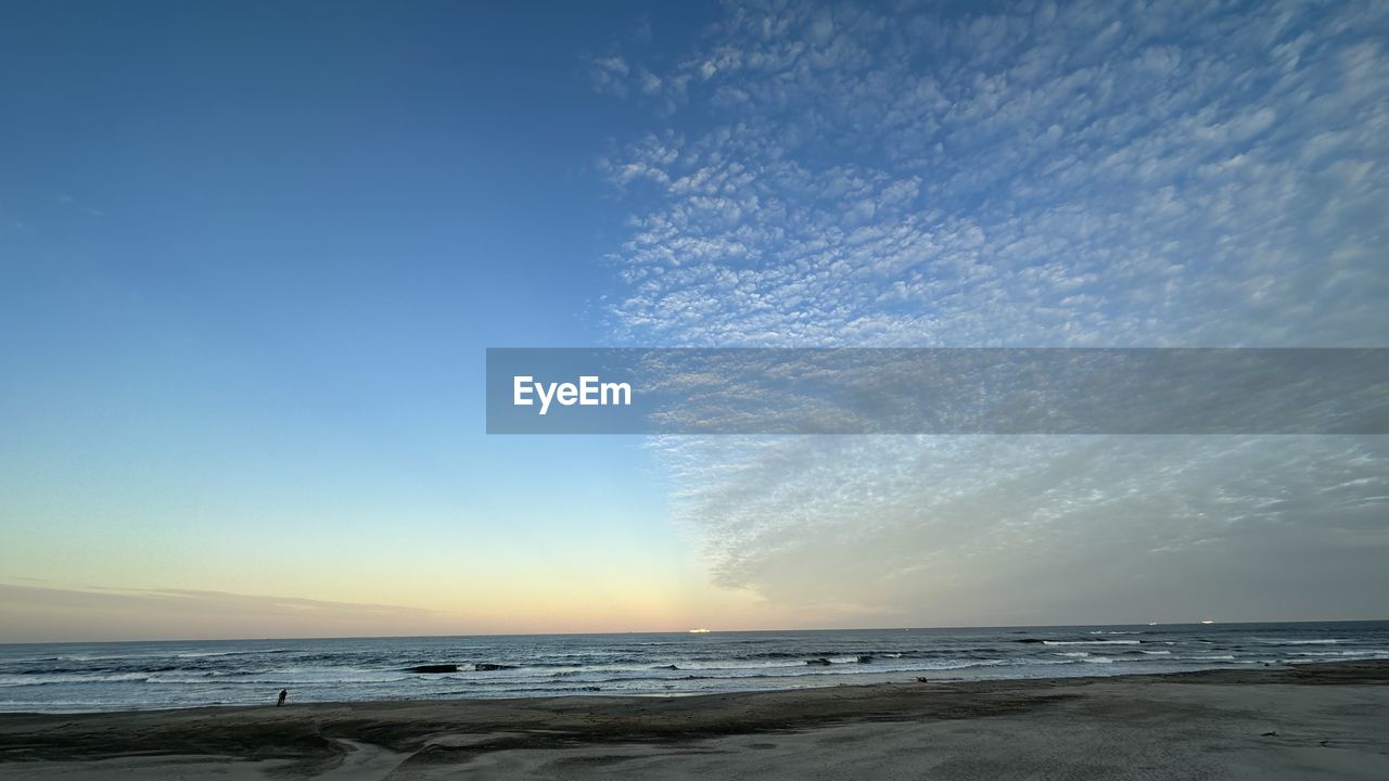 sky, sea, water, beach, land, horizon, ocean, wave, wind wave, beauty in nature, scenics - nature, horizon over water, body of water, shore, nature, cloud, sand, tranquility, coast, tranquil scene, motion, blue, sunset, sunlight, environment, no people, dawn, seascape, idyllic, outdoors, coastline, landscape, travel destinations, clear sky, water sports, water's edge, non-urban scene
