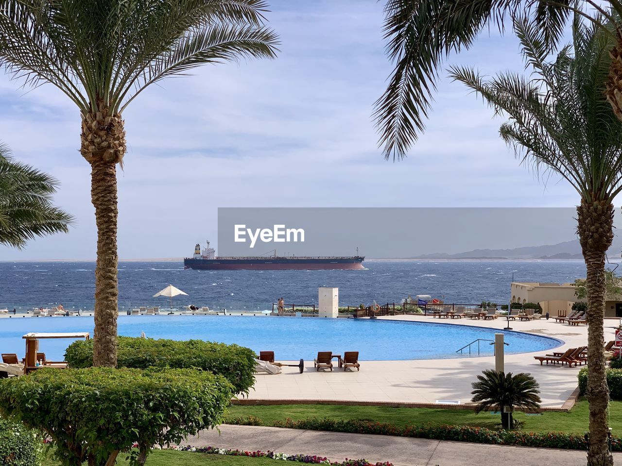 VIEW OF SWIMMING POOL AGAINST SEA