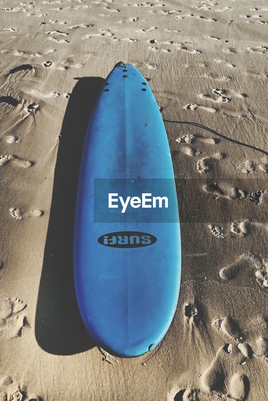 High angle view of blue surfboard at beach