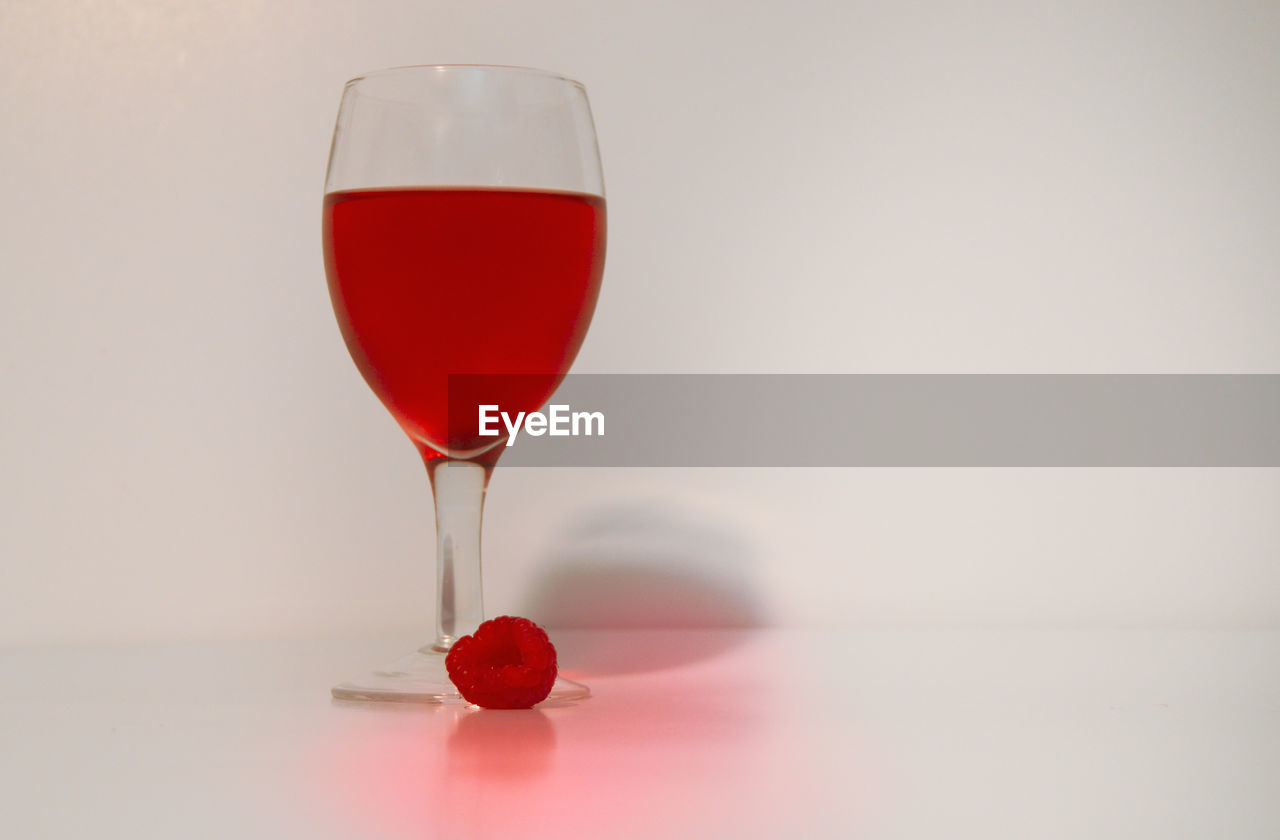 RED WINE IN GLASS ON TABLE