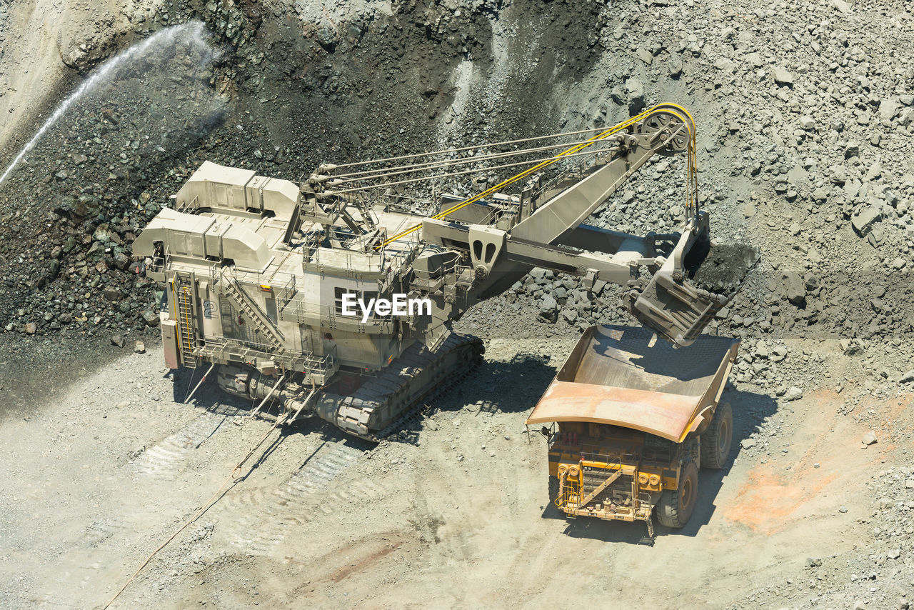 HIGH ANGLE VIEW OF CONSTRUCTION SITE BY CRANE AT DUSK