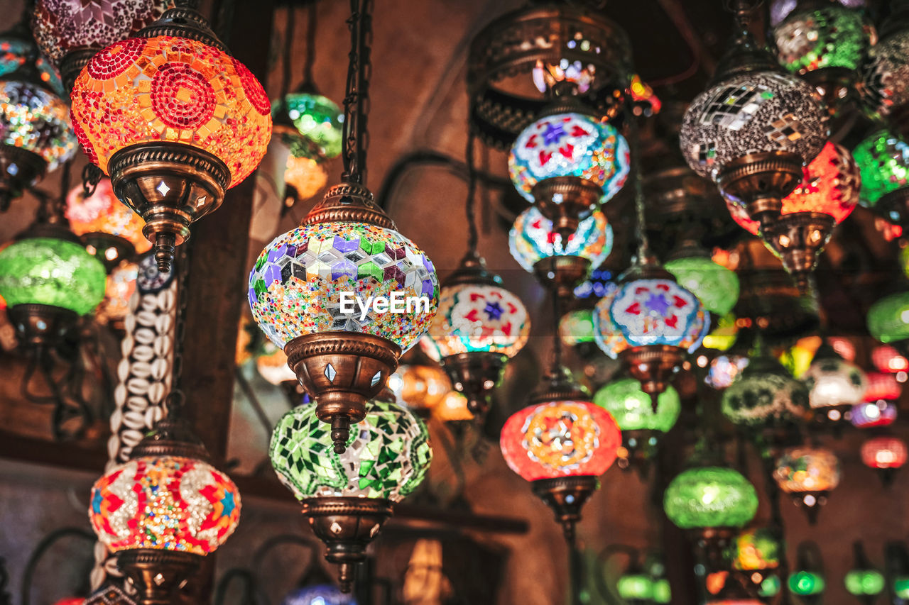 Close-up of illuminated lanterns for sale in store
