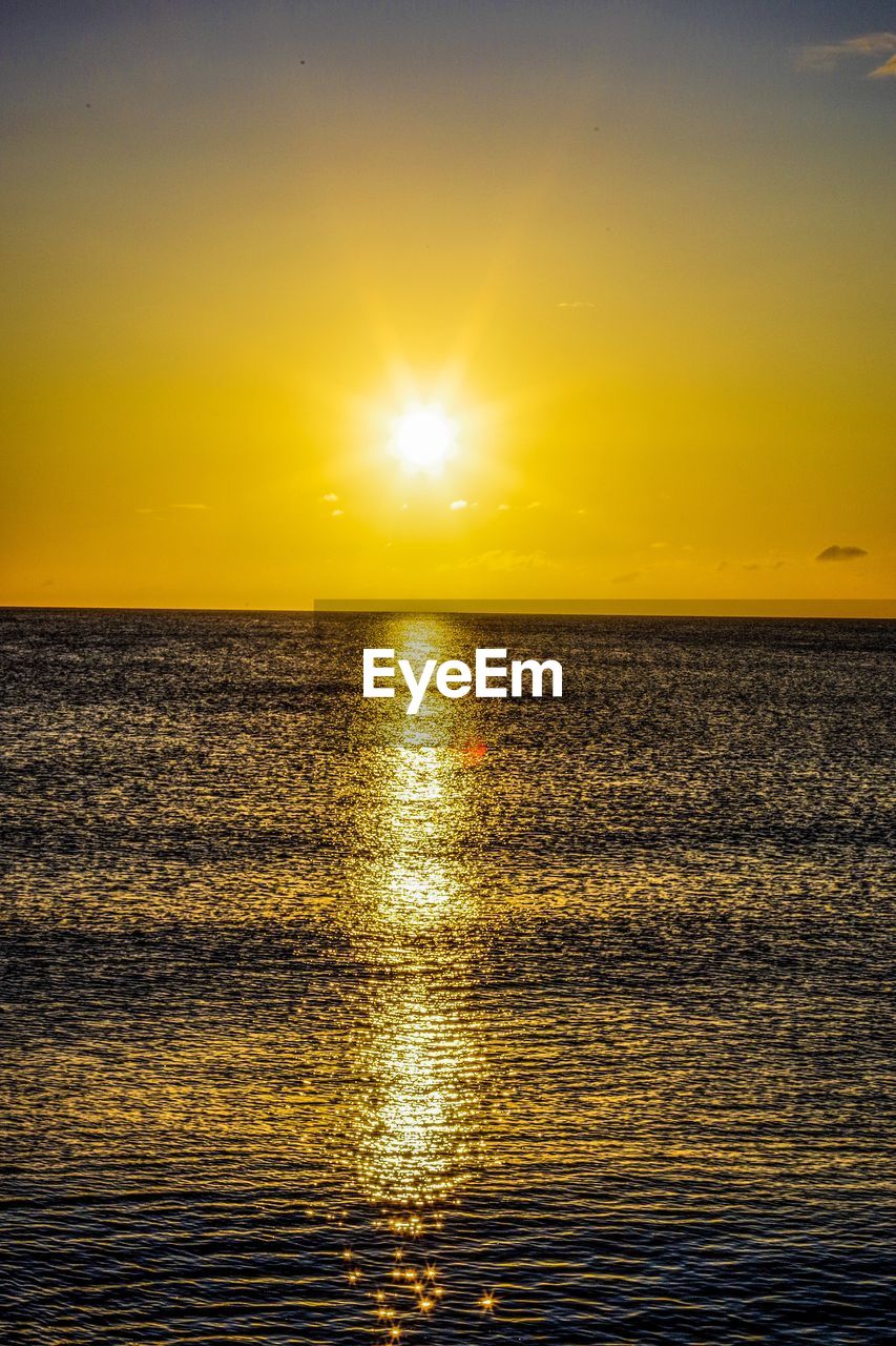 SCENIC VIEW OF SEA AGAINST ORANGE SKY DURING SUNSET
