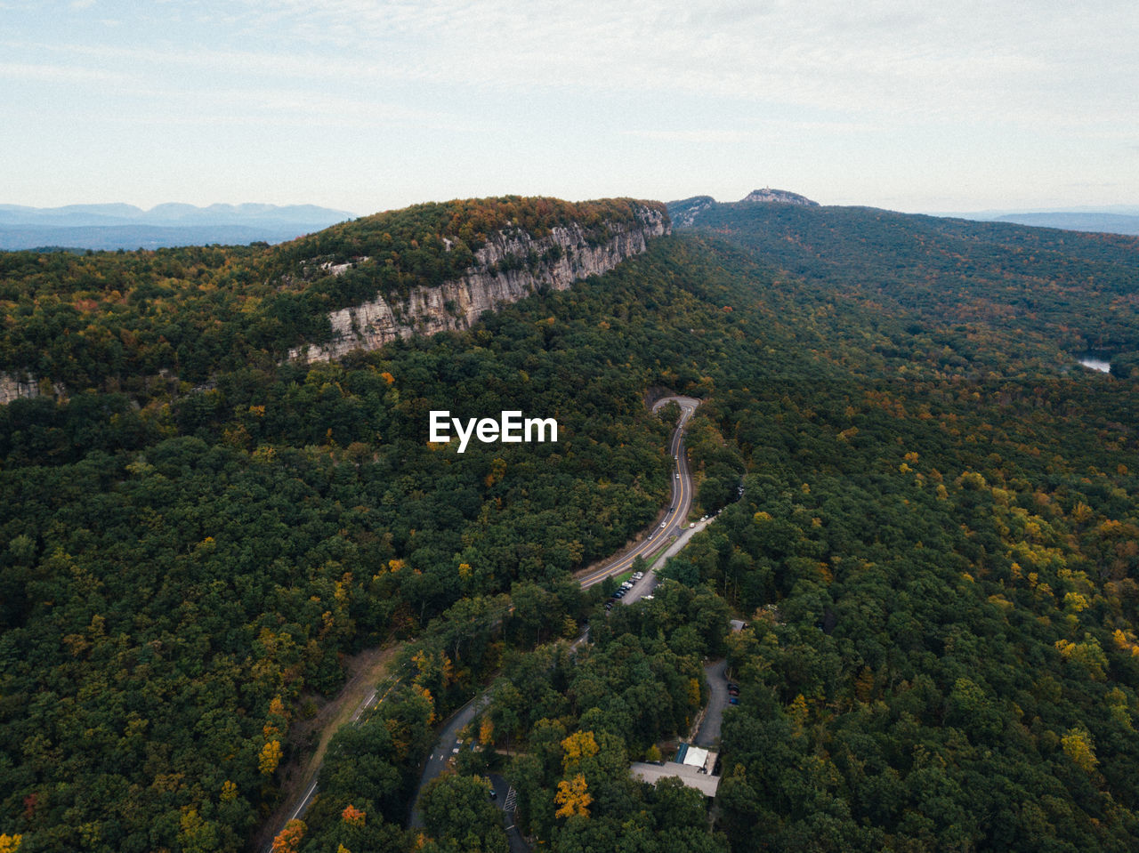 Aerial view of trees and roads on mountains against sky