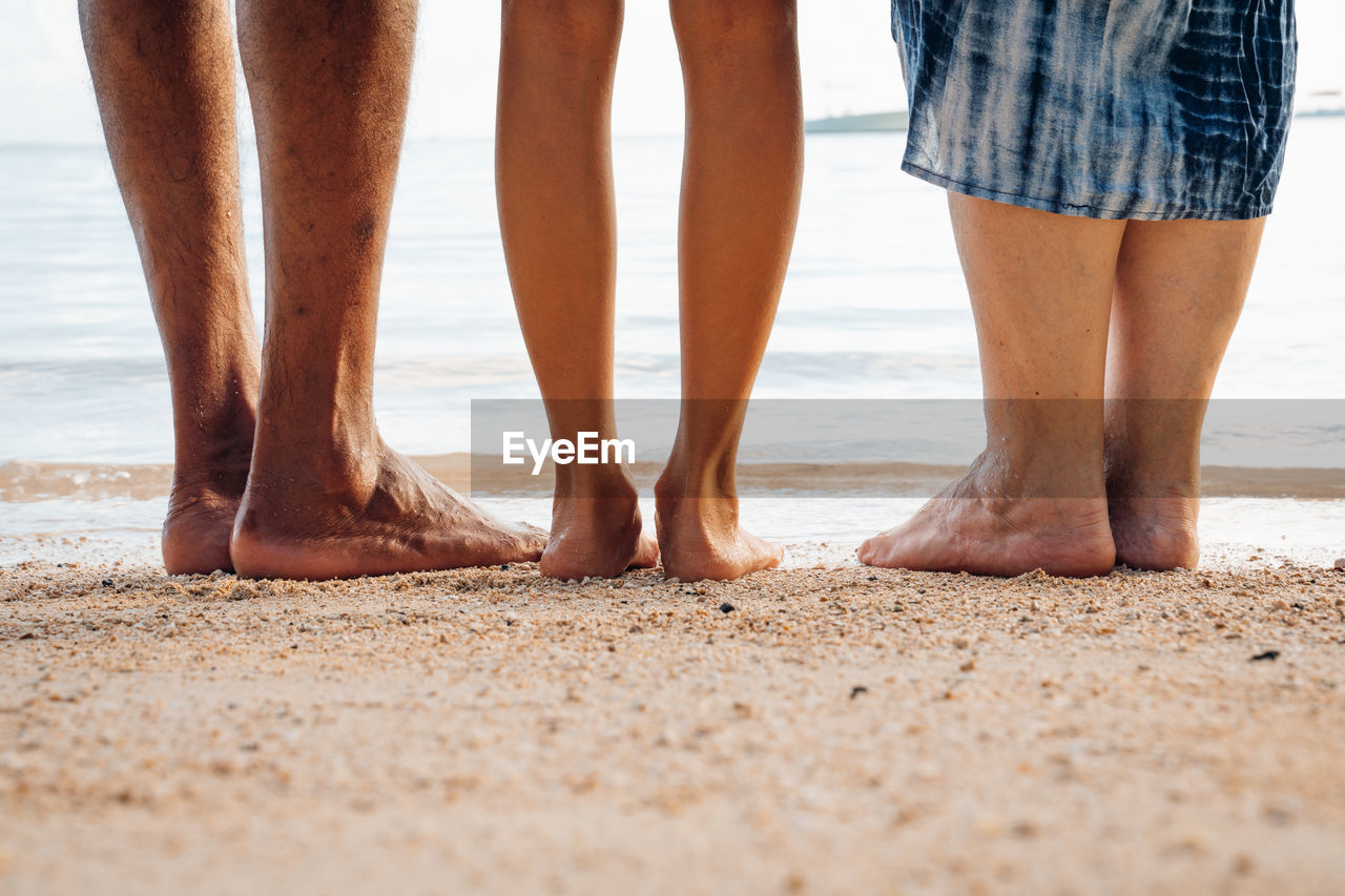 Barefoot family photo on the beach.