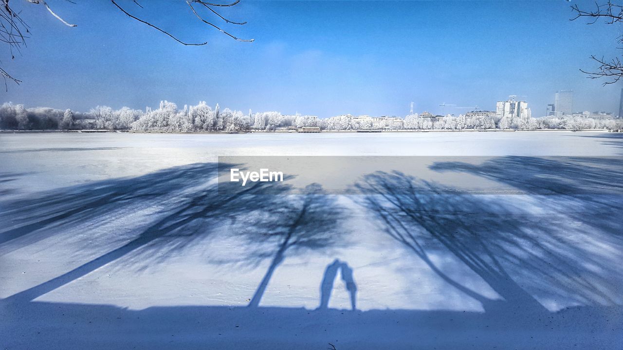 Scenic view of frozen landscape against blue sky