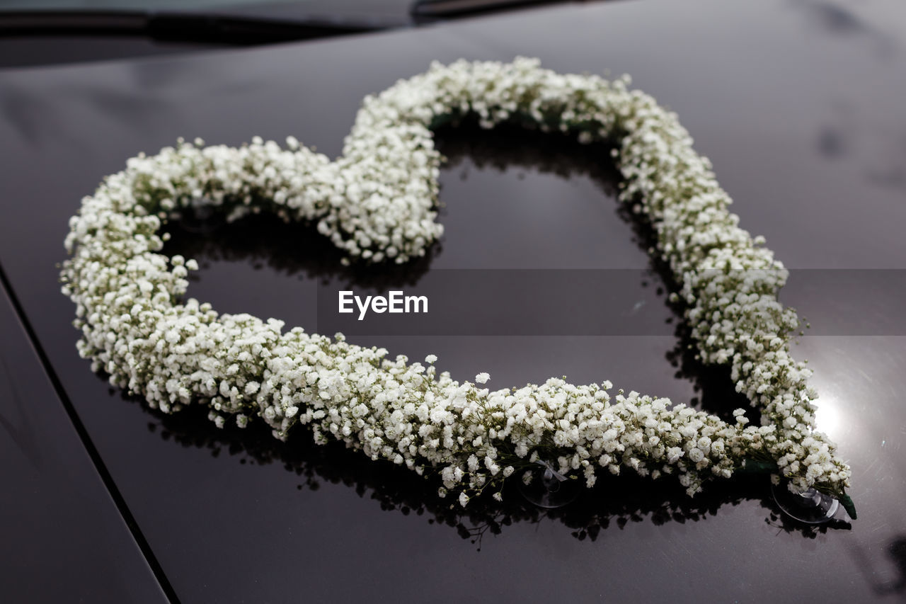 CLOSE-UP OF HEART SHAPE ON WHITE TABLE