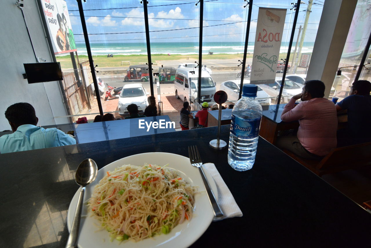 PEOPLE EATING FOOD ON RESTAURANT