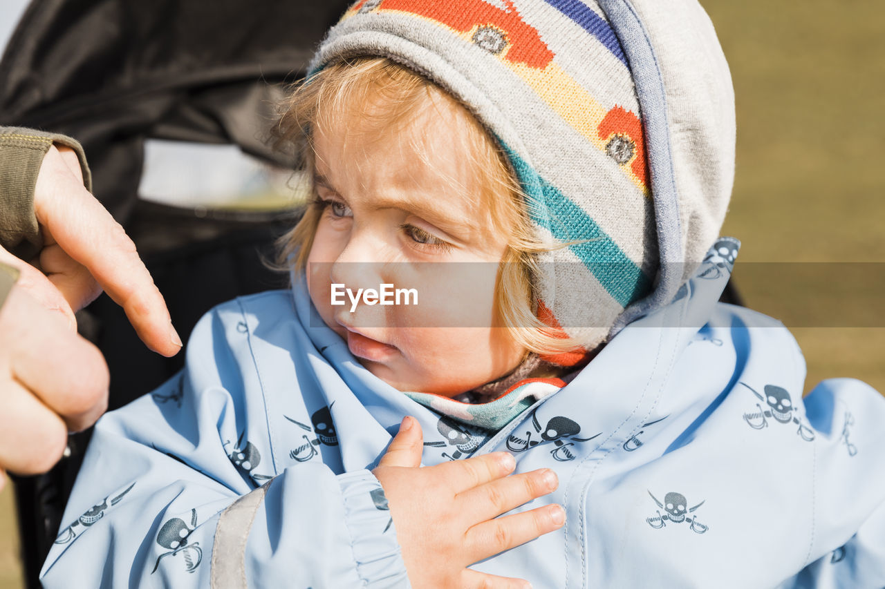 Close-up of cute girl looking away during winter