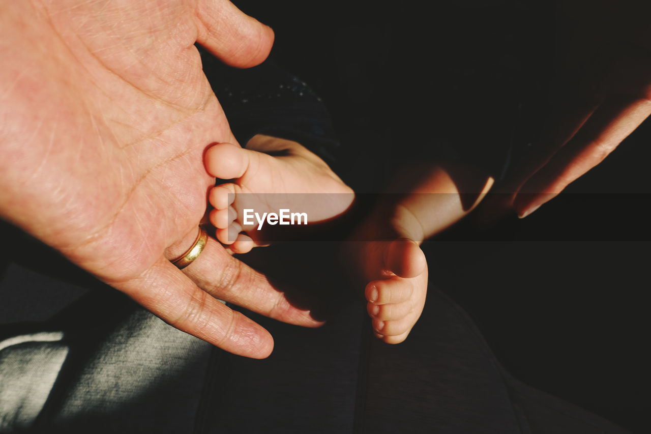 Close-up of hands holding baby feet