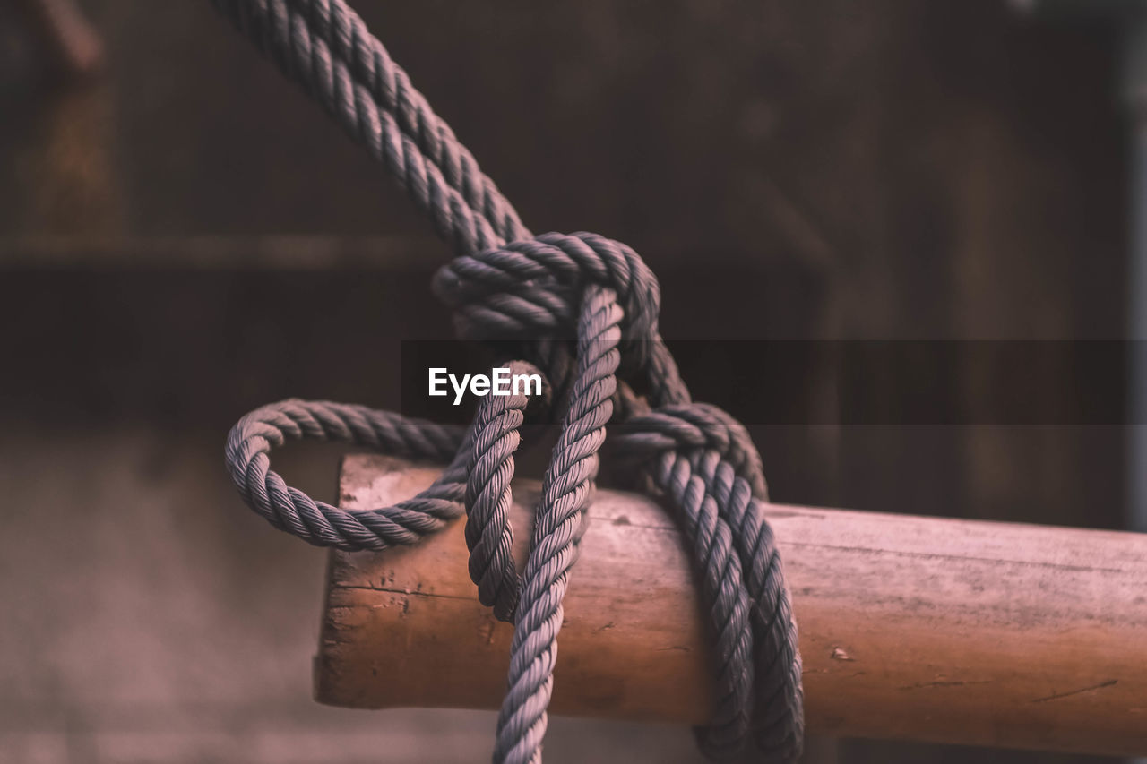 Close-up of rope tied on wood