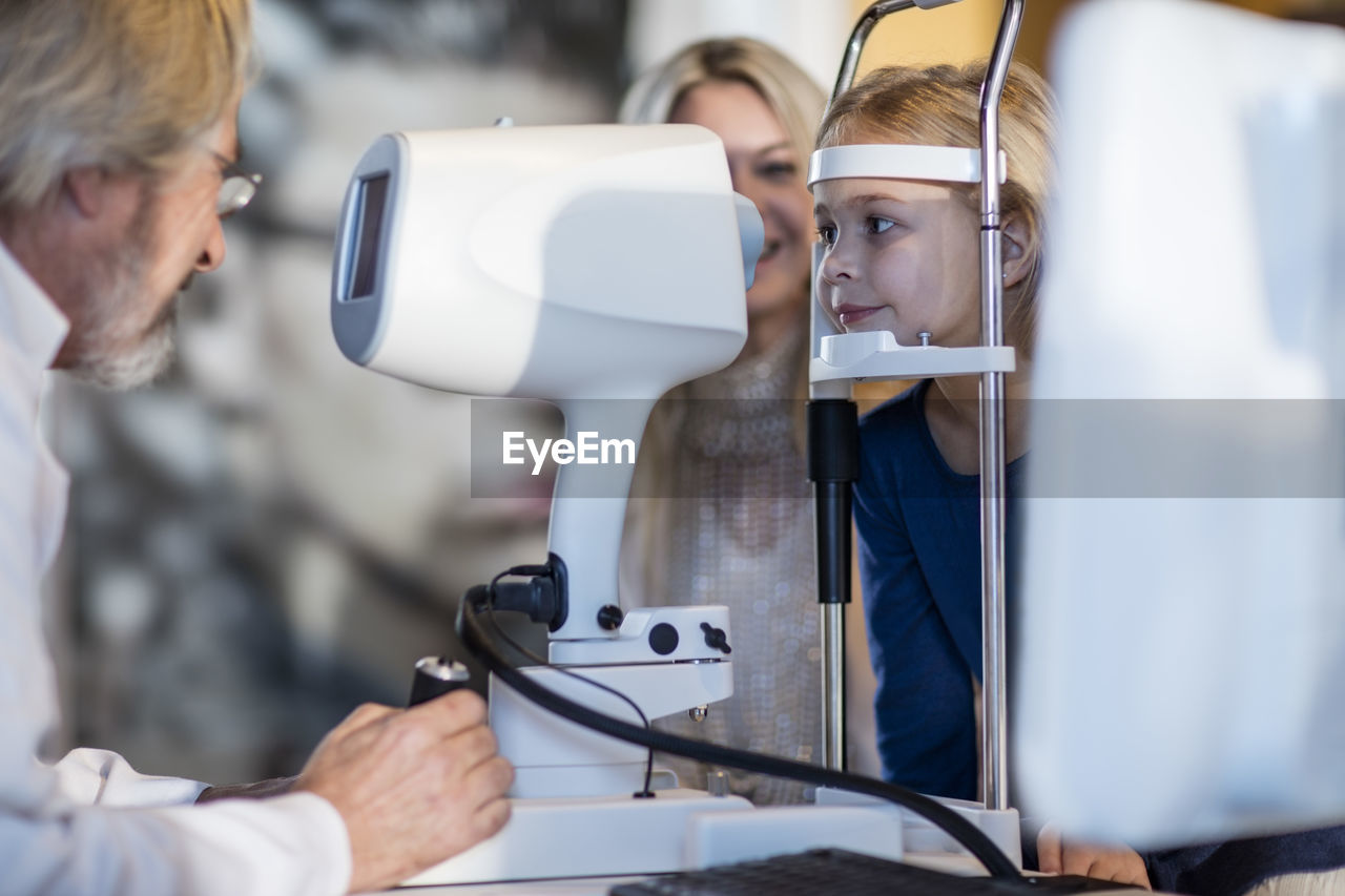 Girl doing eye test at the optometrist