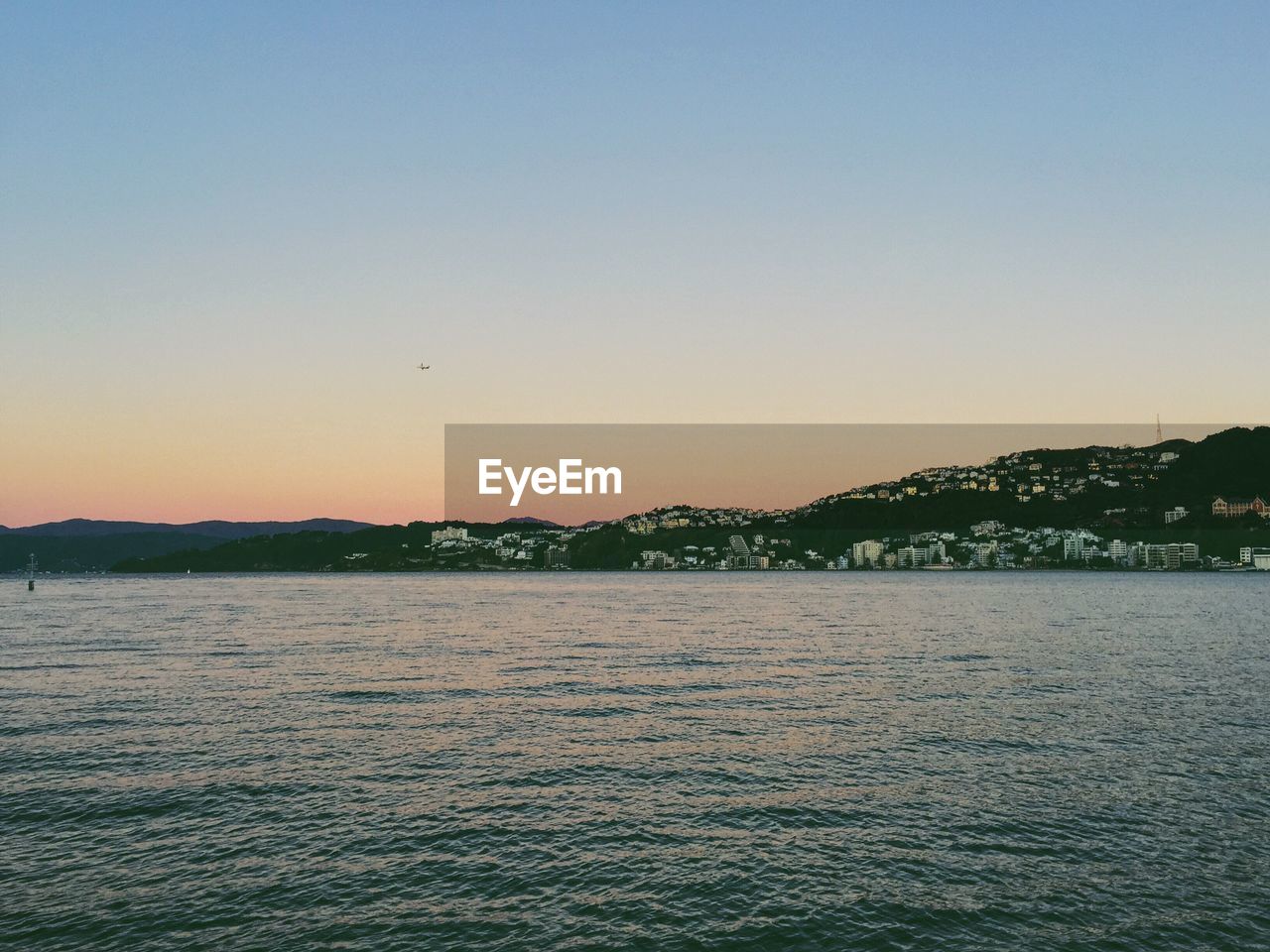 Scenic view of sea against clear sky during sunset