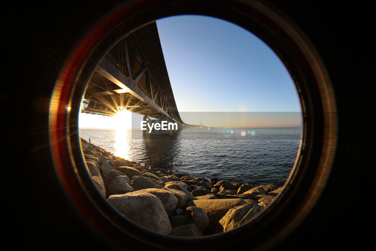 Sun seen through the oresund bridge at the viewpoint near limhamn sweden. wide angle, clear sky