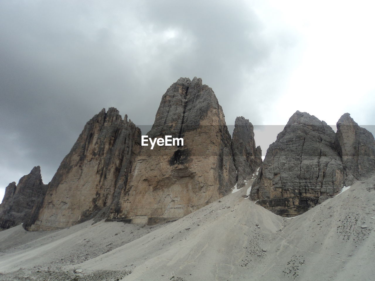 Scenic view of mountains against cloudy sky