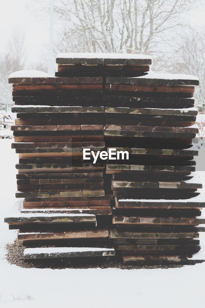 Wooden pallets on field during winter