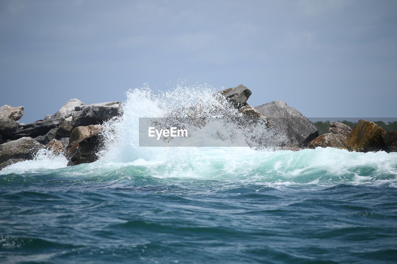 Ocean wave crashing on rocks