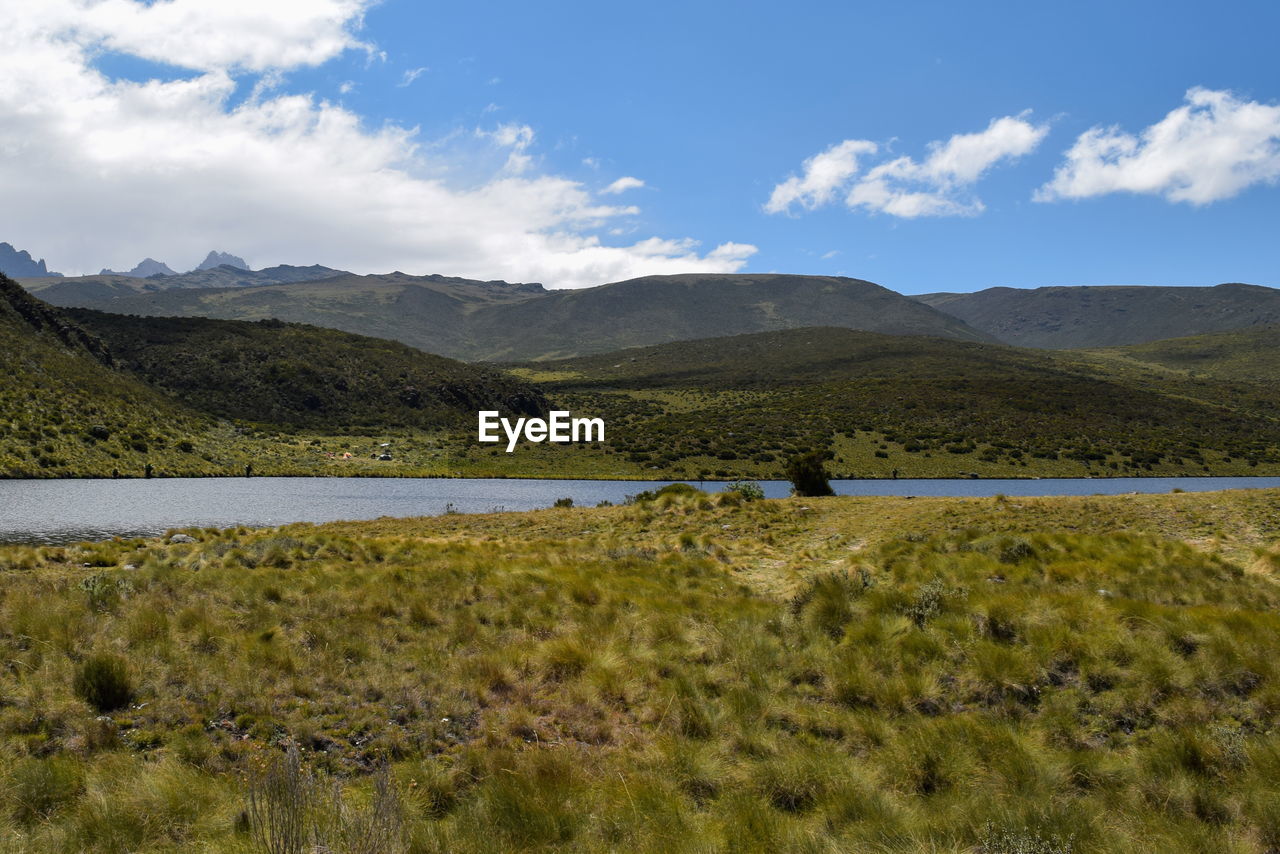 Lake against a panoramic mountain landscapes of mount kenya, lake ellis in mount kenya