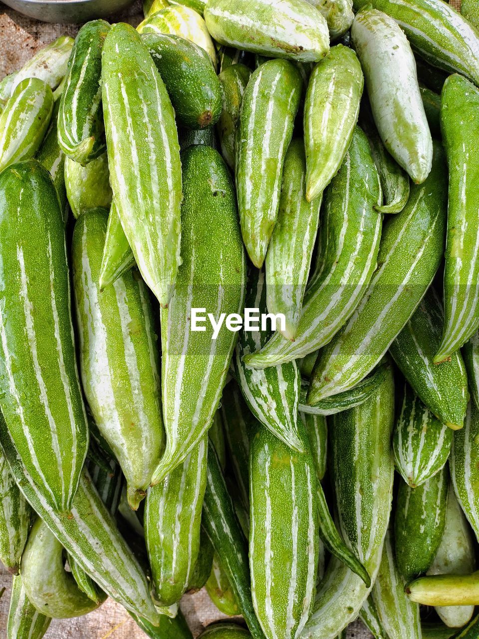 Full frame shot of green snake gourds