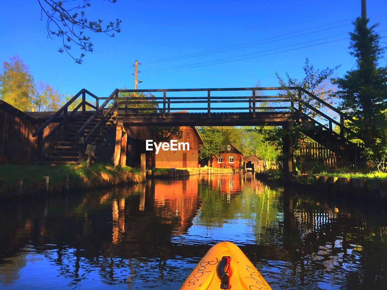 Bridge over lake against blue sky