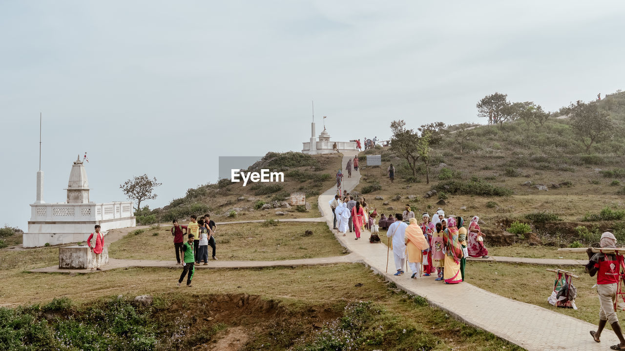 Hindu jain pilgrims people walking toward shikharji temple. parasnath, giridih, jharkhand