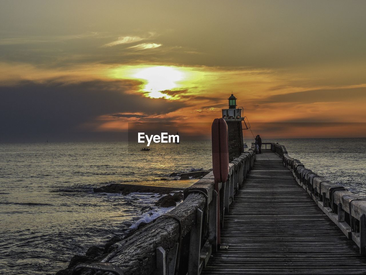 PIER ON SEA AGAINST SKY AT SUNSET