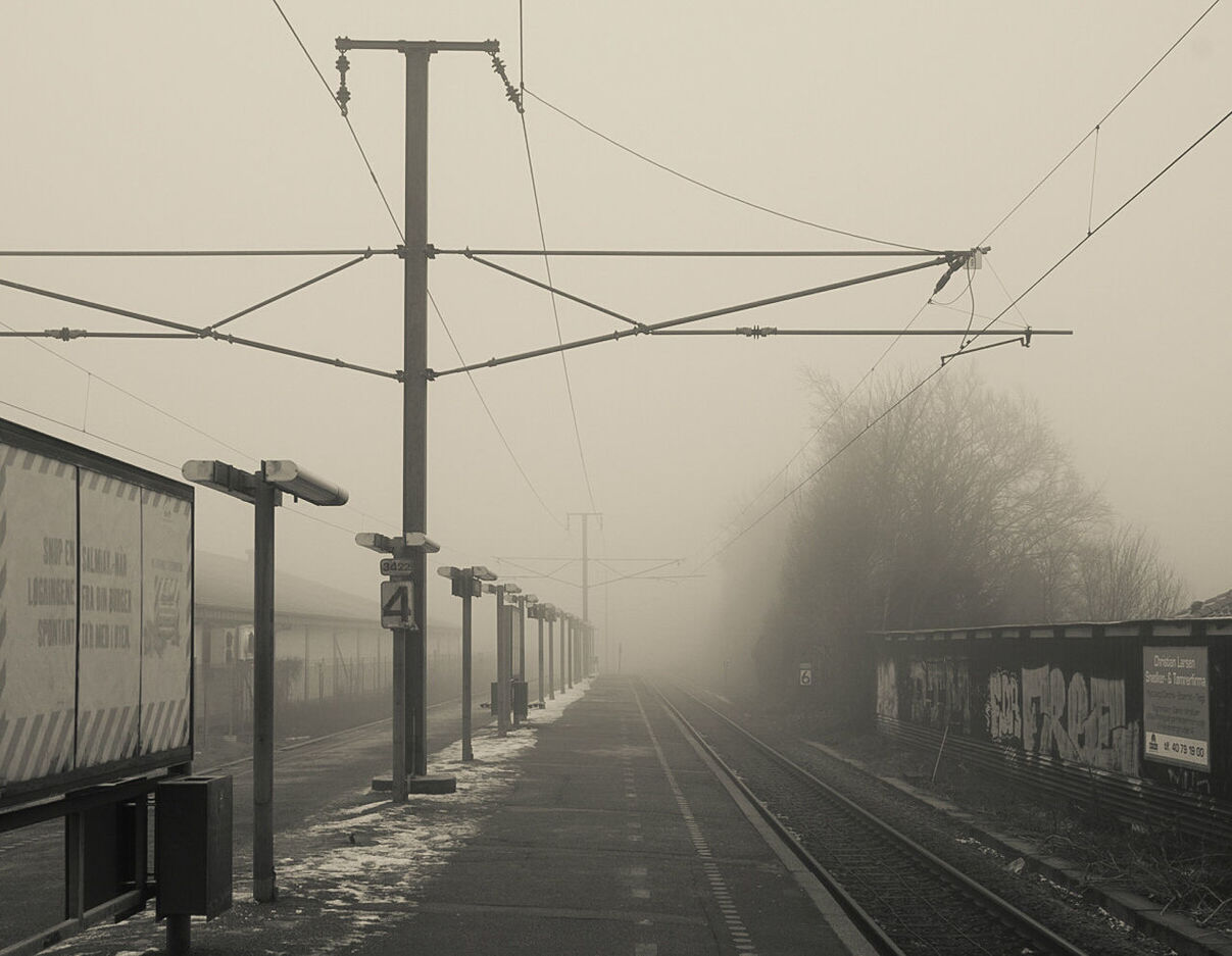 Railroad station against sky during foggy weather