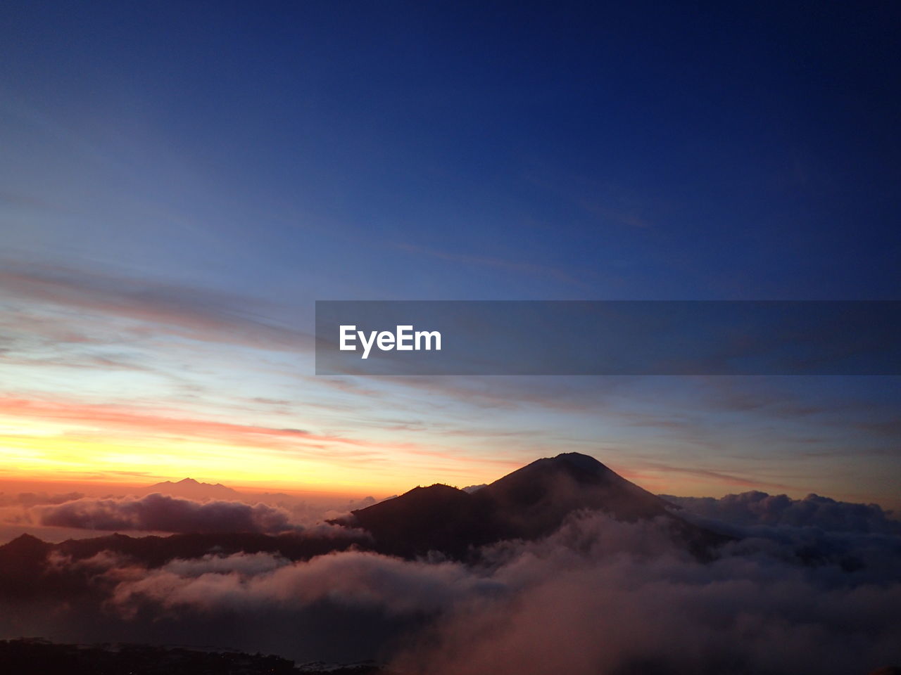 Scenic view of mountains against sky at sunset