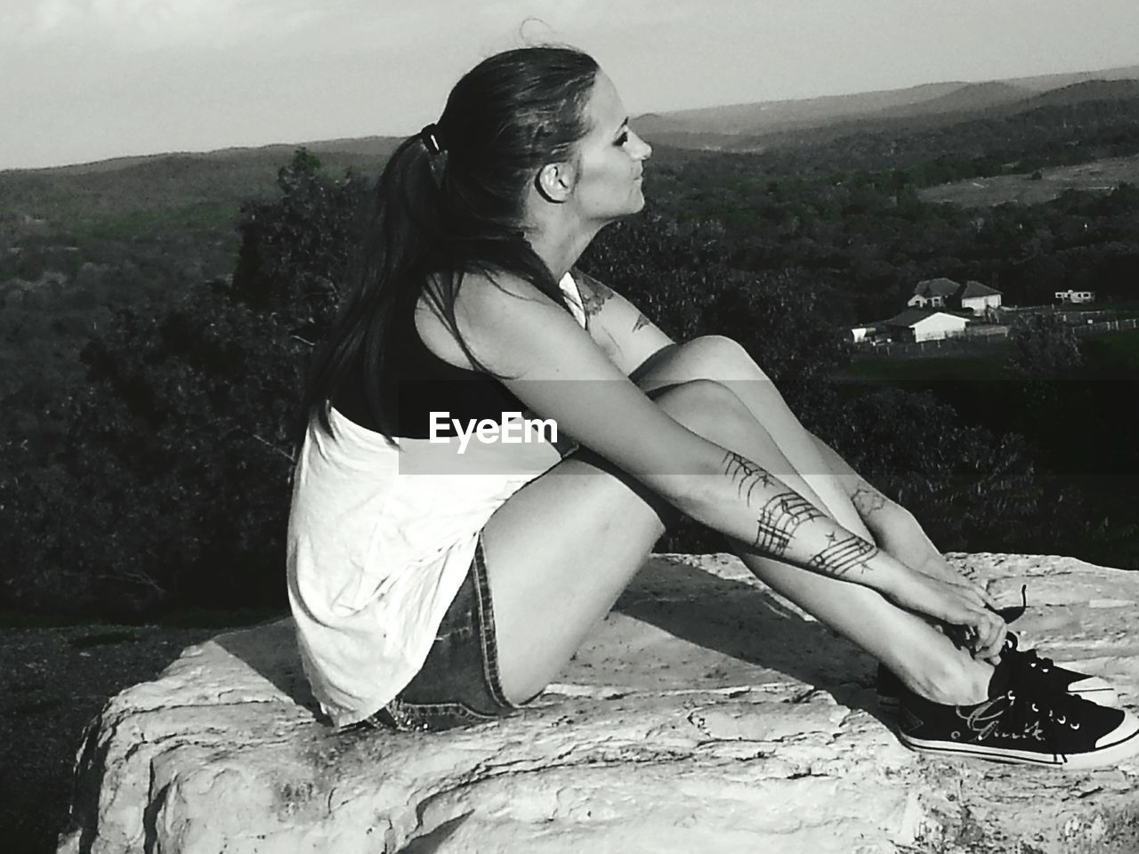 WOMAN STANDING ON MOUNTAIN