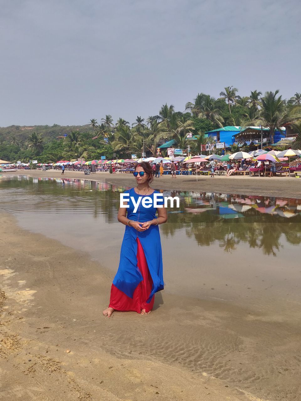 Woman on beach against sky