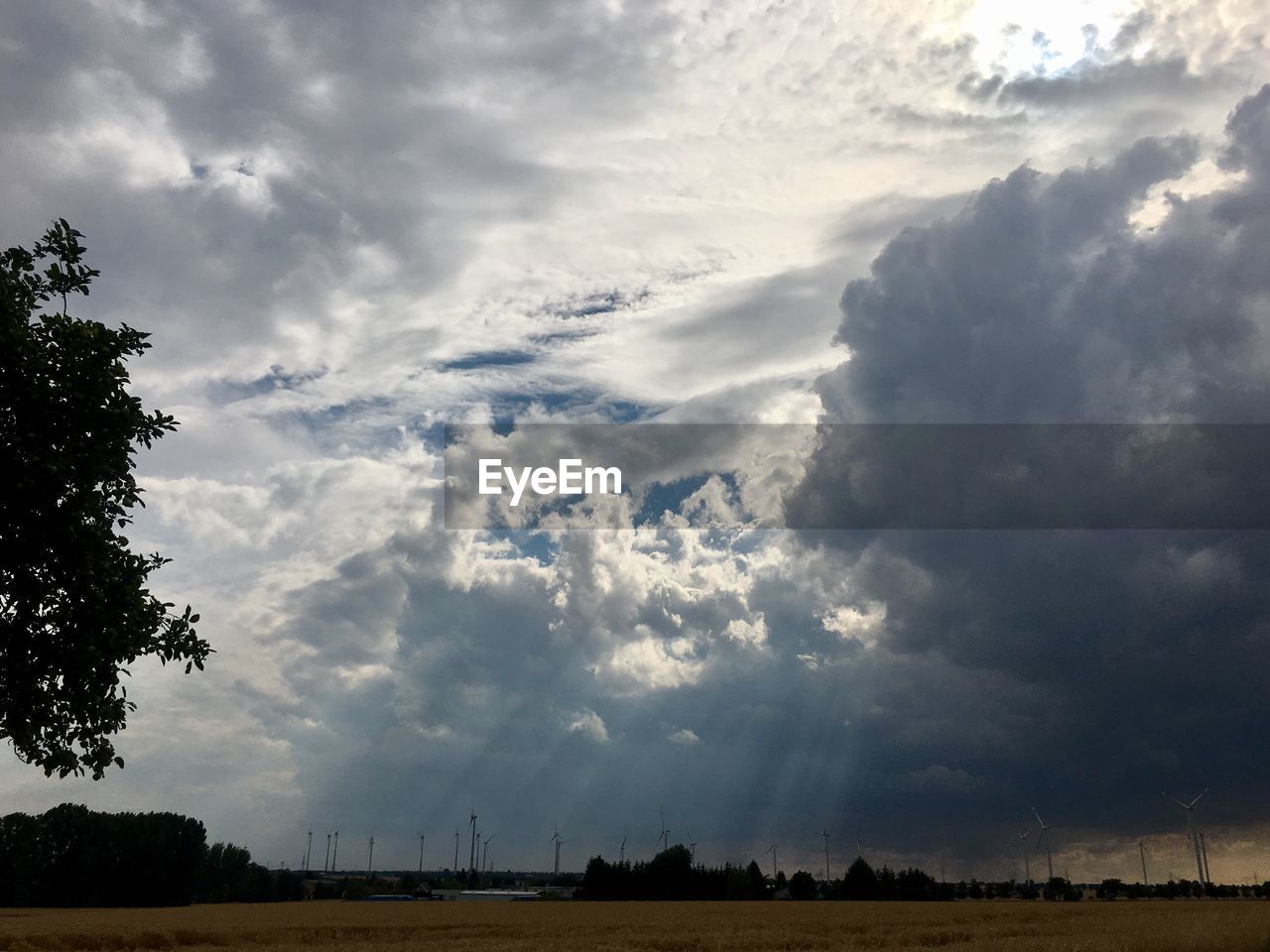 VIEW OF STORM CLOUDS OVER FIELD