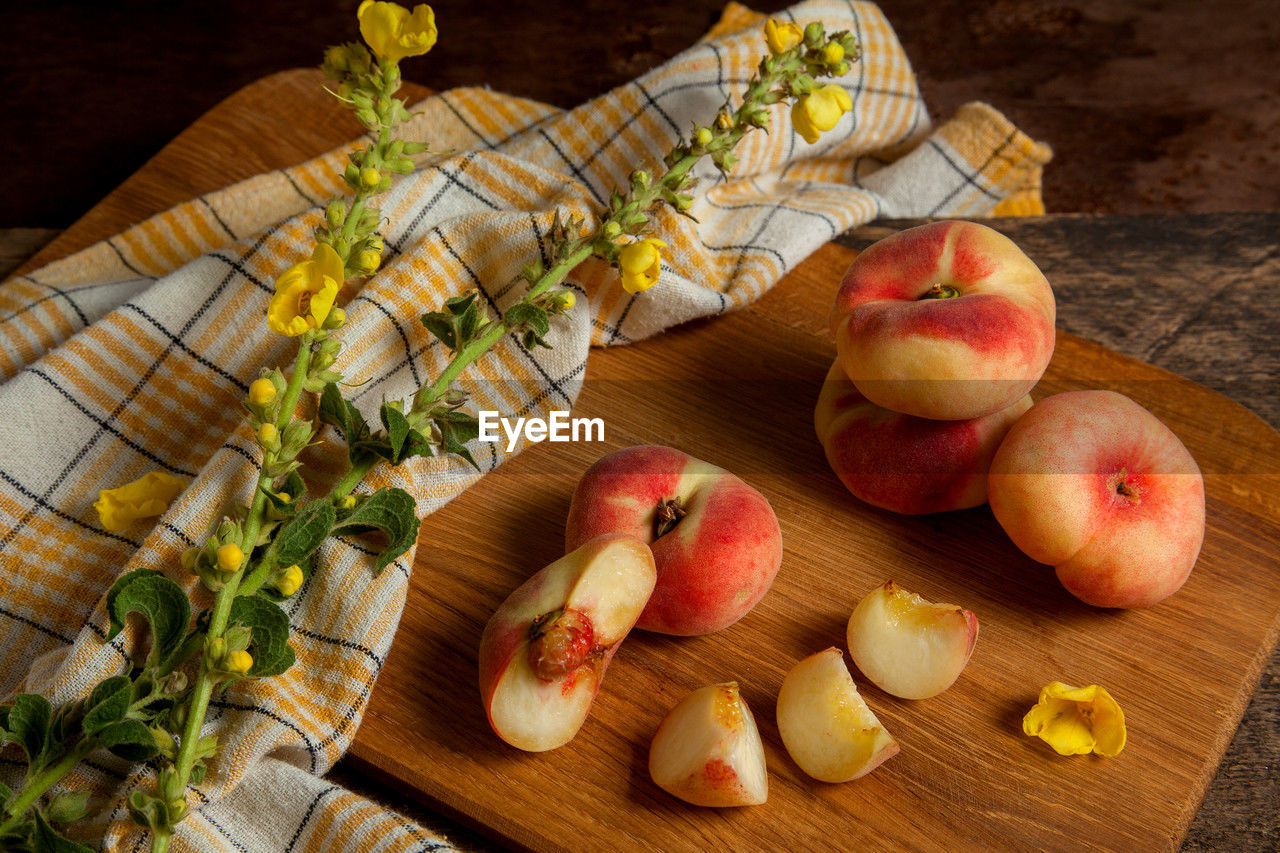 food and drink, food, healthy eating, fruit, wellbeing, freshness, apple, wood, plant, no people, cutting board, high angle view, produce, indoors, still life, apple - fruit, table, peach, slice, vegetable, organic, studio shot, meal