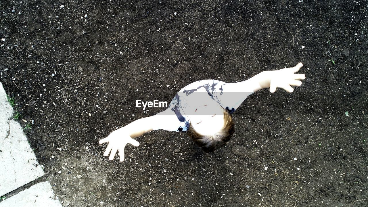 HIGH ANGLE VIEW OF WOMAN LYING ON STREET