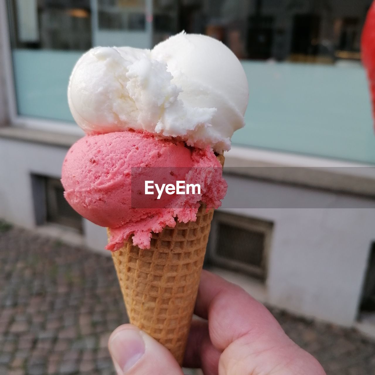 Cropped hand holding ice cream cone