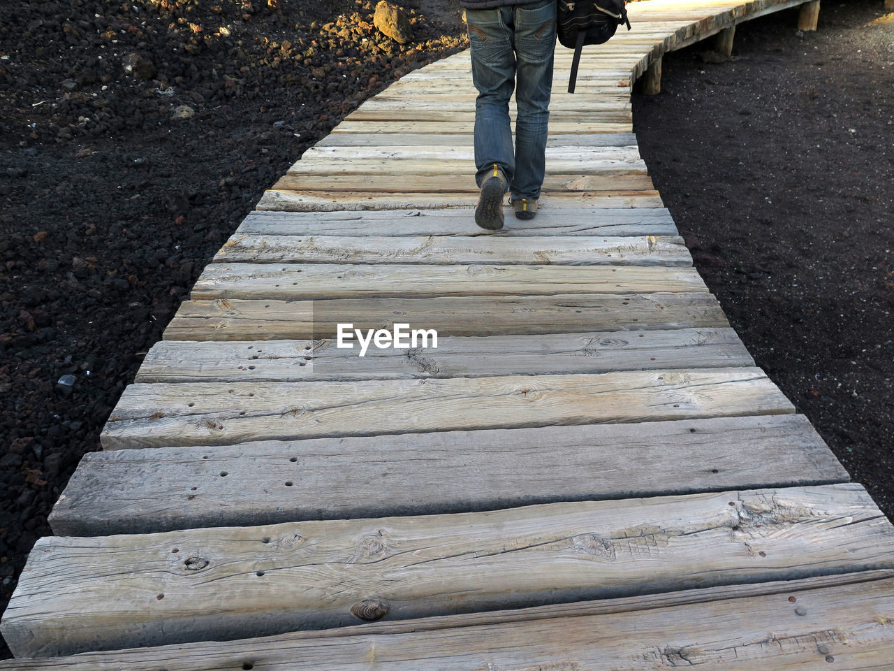 Low section of man walking on footpath