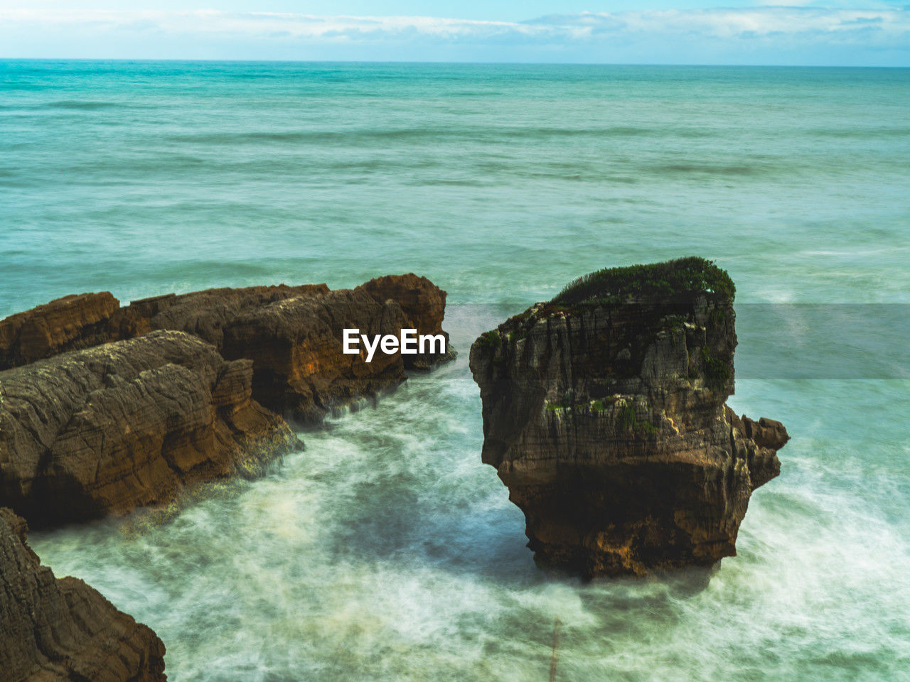 sea, water, rock, land, beauty in nature, scenics - nature, ocean, beach, shore, body of water, wave, horizon over water, sky, horizon, nature, coast, cliff, wind wave, terrain, islet, tranquility, rock formation, tranquil scene, motion, no people, bay, idyllic, outdoors, travel destinations, day, cove, sports, blue, water sports, coastline, seascape, non-urban scene, cloud, travel, environment