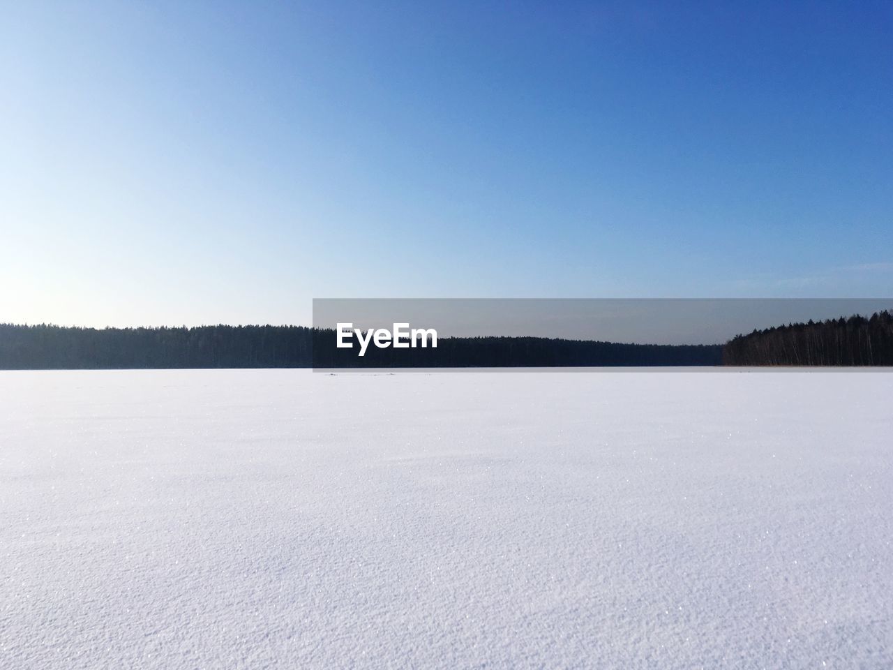 SCENIC VIEW OF FROZEN LAKE AGAINST SKY