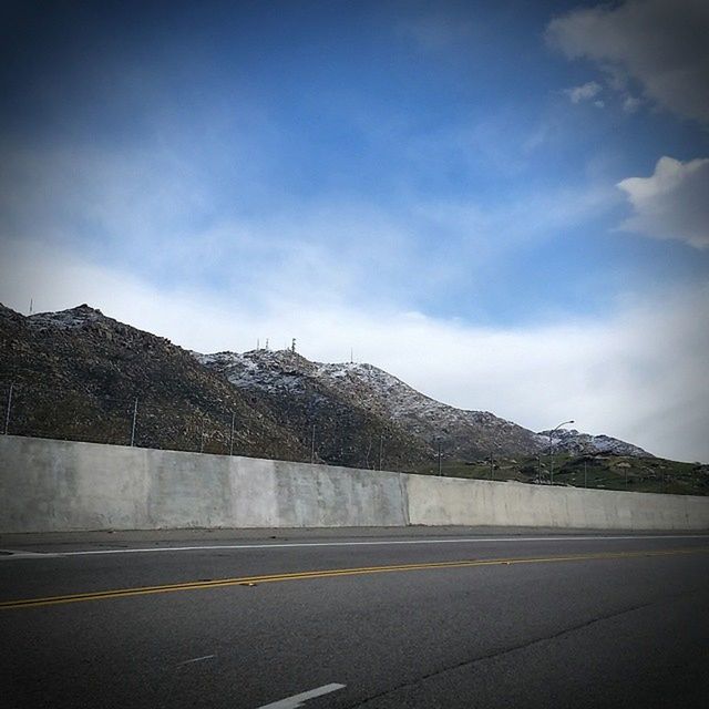 MOUNTAIN RANGE AGAINST CLOUDY SKY