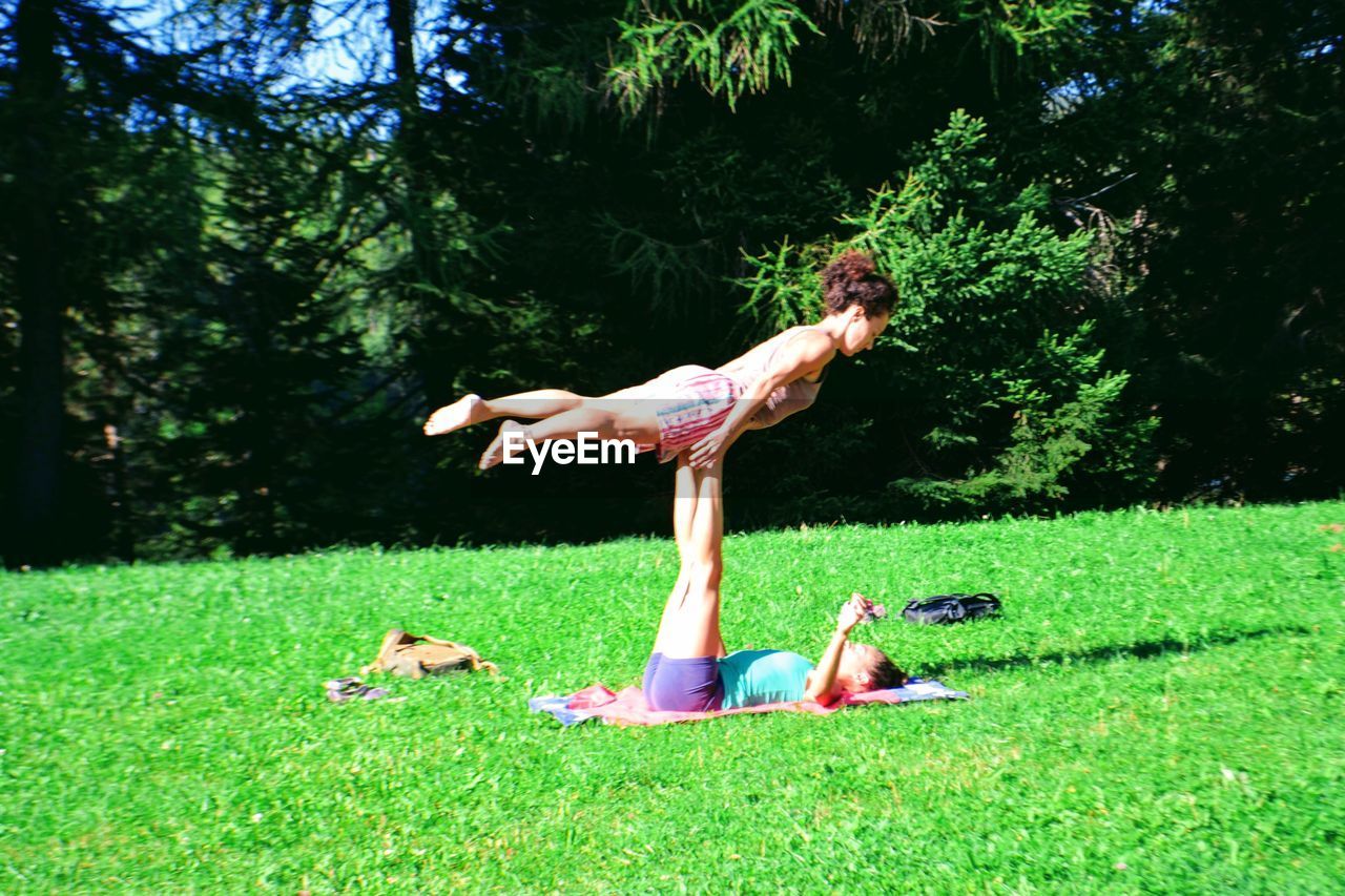 Female friends exercising at park