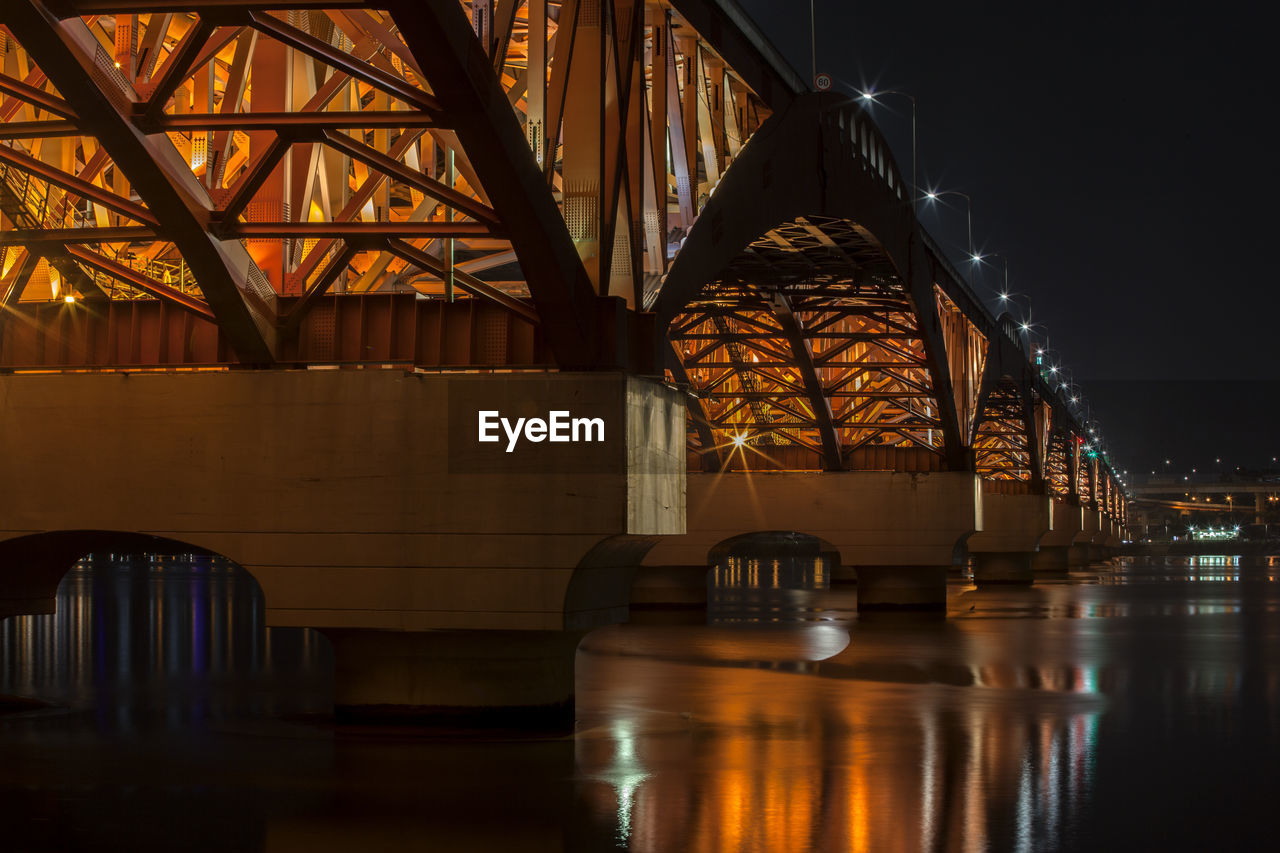 Illuminated seongsan bridge over han river against sky at night