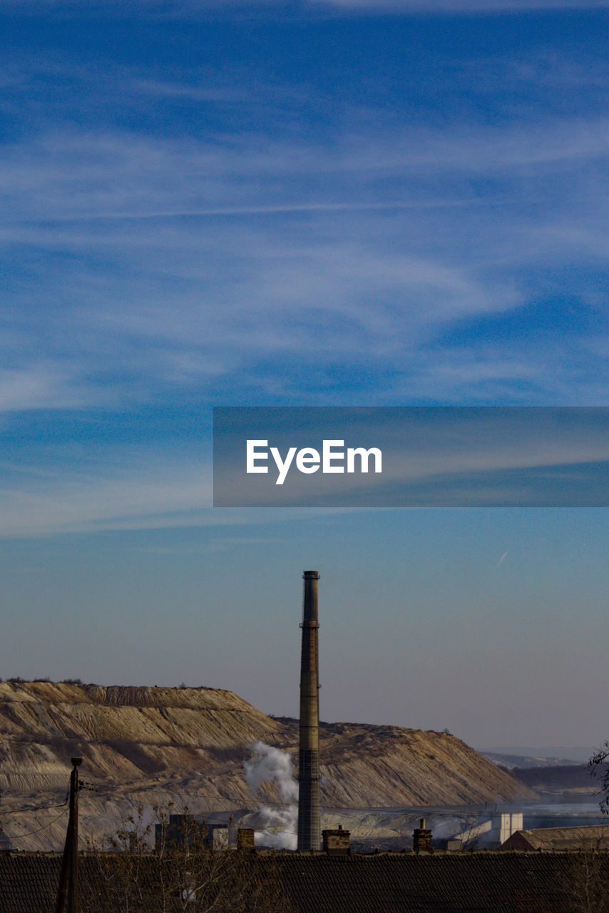  industrial chimneys against sky