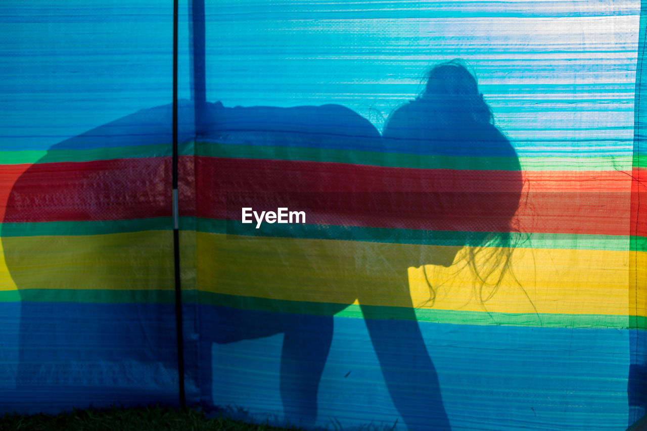 Shadow of girl on colorful fabric